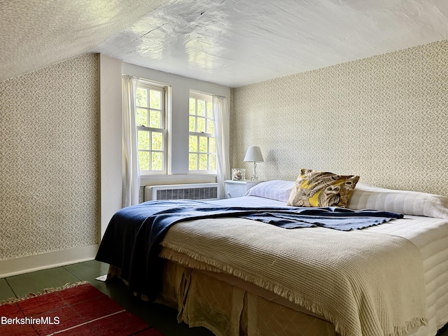 bedroom featuring a wall mounted air conditioner