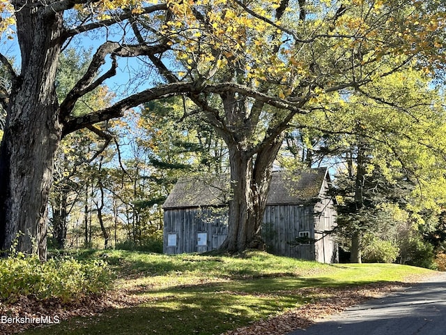 view of home's exterior with an outbuilding