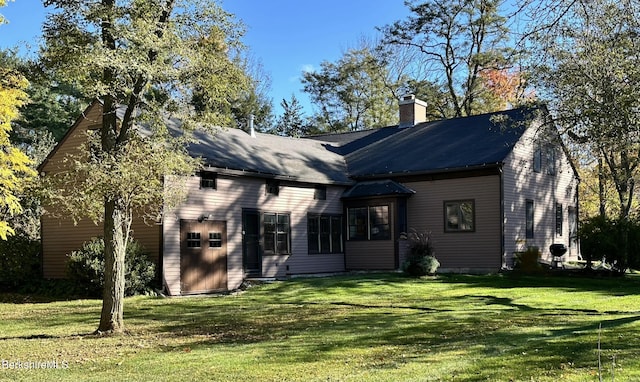 rear view of property with a yard