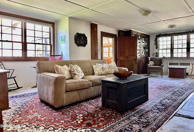 living room featuring a wealth of natural light and radiator heating unit