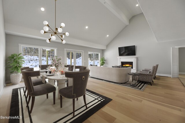 dining space with french doors, beam ceiling, high vaulted ceiling, and light hardwood / wood-style flooring