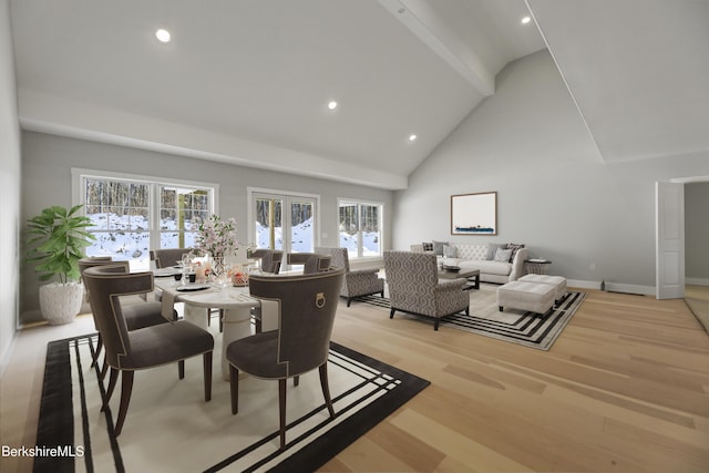 dining space featuring beamed ceiling, high vaulted ceiling, french doors, and light wood-type flooring