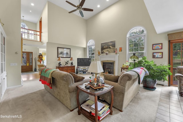 living room with ceiling fan, high vaulted ceiling, and light tile patterned flooring