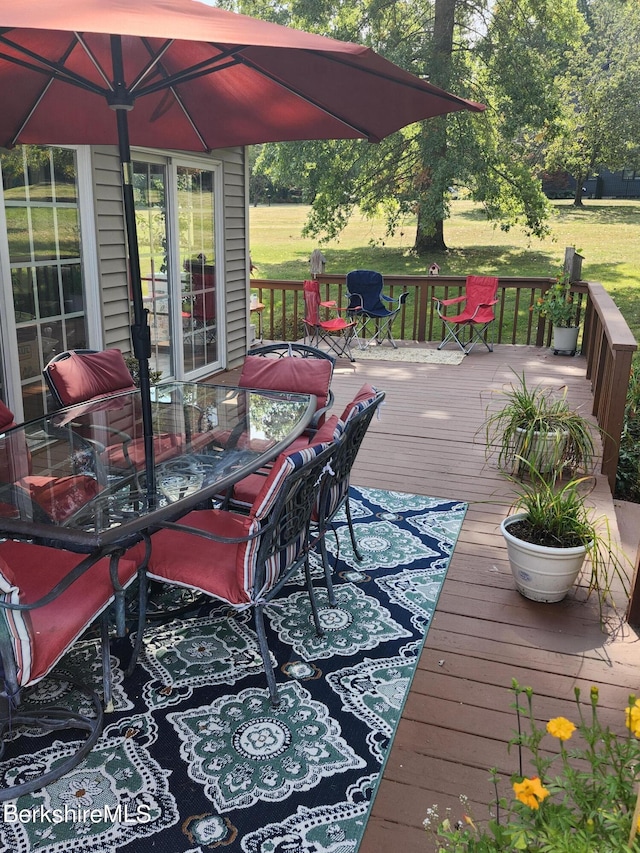 wooden terrace with a yard