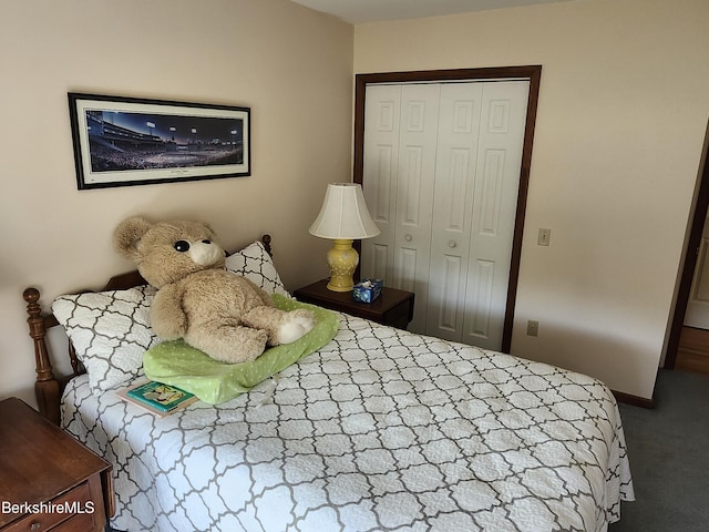 bedroom with dark colored carpet and a closet