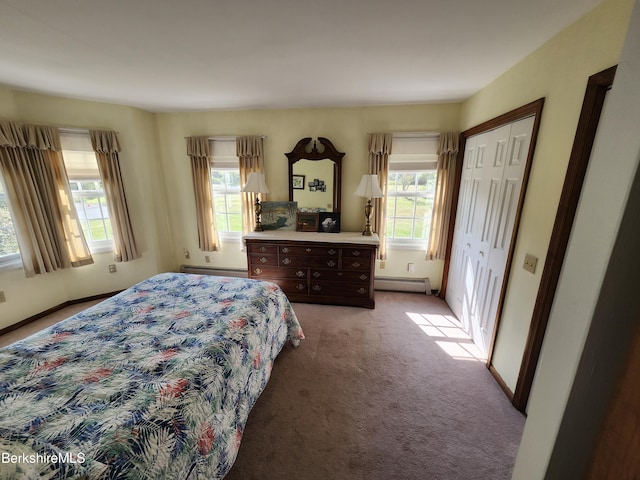 bedroom featuring baseboard heating and light carpet