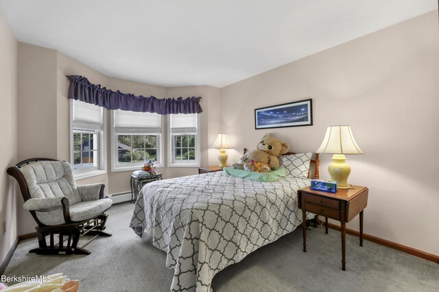 bedroom with baseboard heating and carpet floors