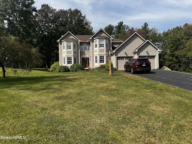 view of front of house featuring a garage and a front lawn