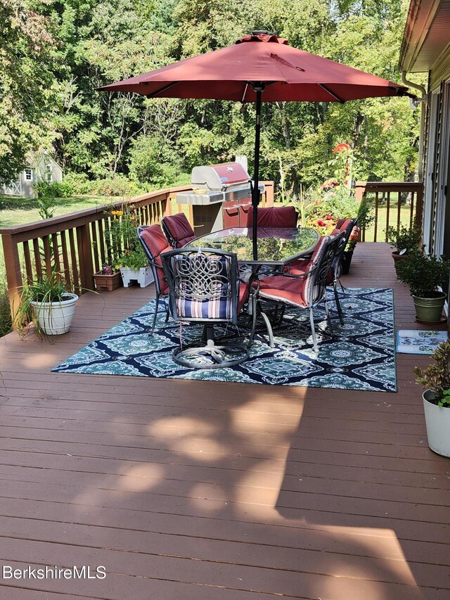 wooden deck featuring area for grilling