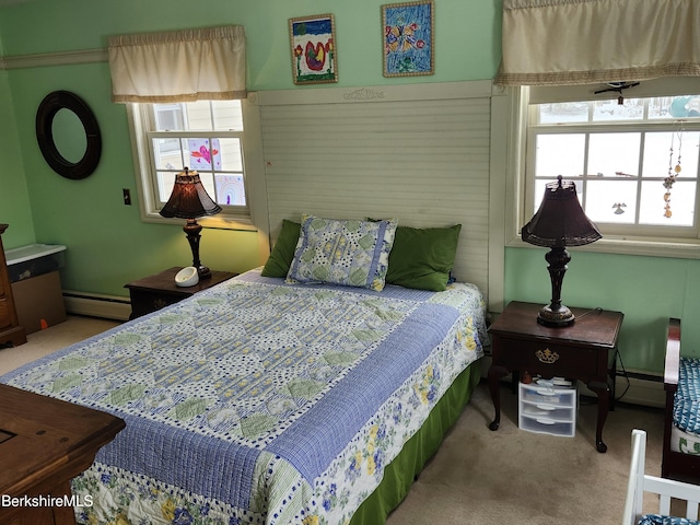 bedroom with baseboard heating and carpet