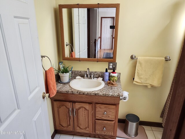 full bathroom with tile patterned floors, shower / bathtub combination with curtain, vanity, and toilet