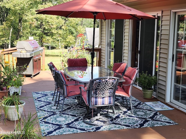 view of patio / terrace featuring a wooden deck and a grill