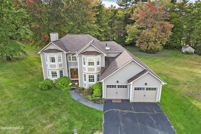 view of front facade with a garage and a front lawn