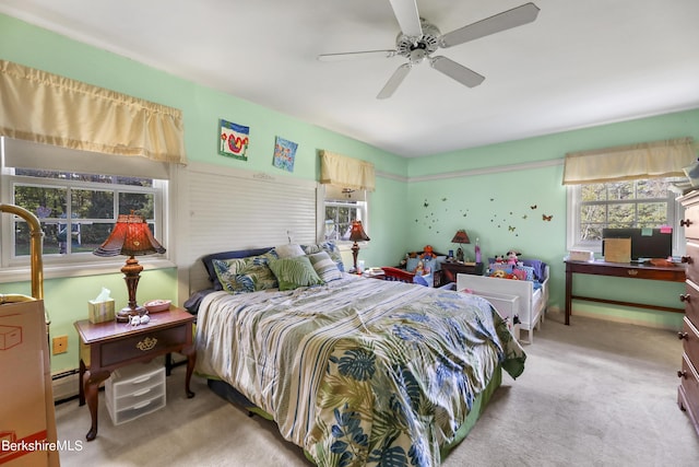 carpeted bedroom with a baseboard radiator and ceiling fan