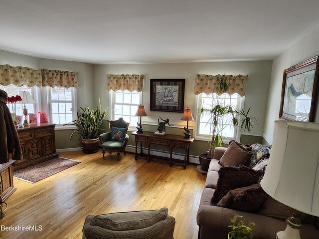 sitting room with a baseboard radiator and light wood-type flooring