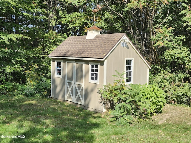 view of outbuilding with a lawn