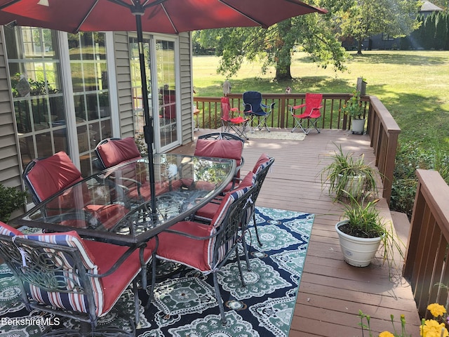 wooden terrace featuring a lawn