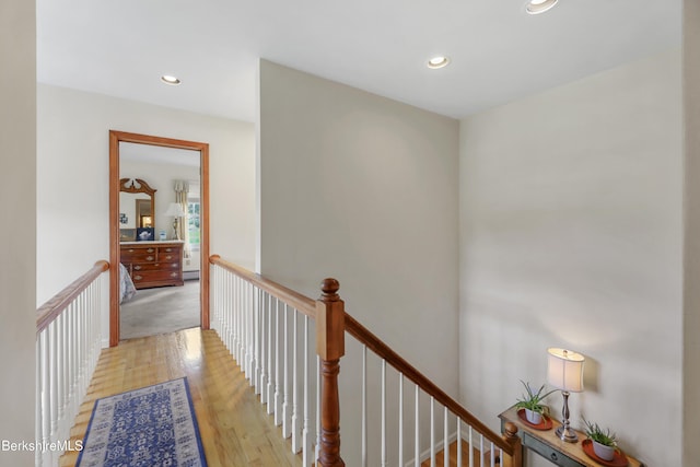 corridor featuring a baseboard heating unit and light hardwood / wood-style floors