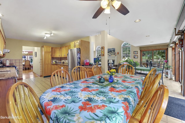 tiled dining area with ceiling fan