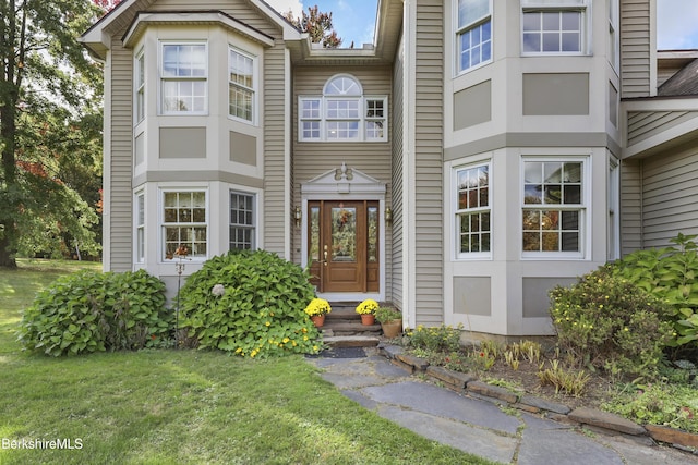 doorway to property featuring a yard