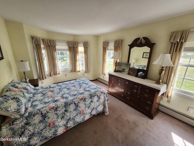 bedroom with multiple windows, a baseboard radiator, and light colored carpet