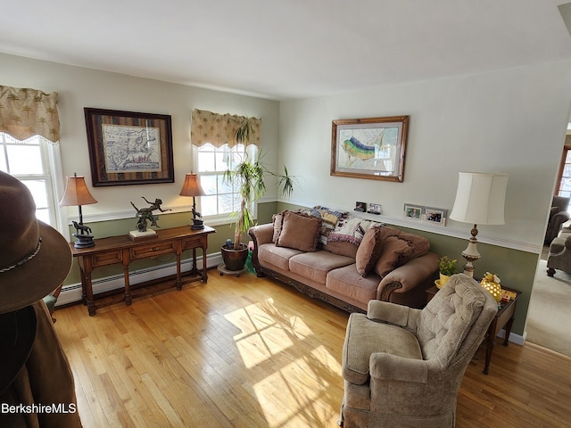 living room featuring light hardwood / wood-style flooring and a baseboard heating unit