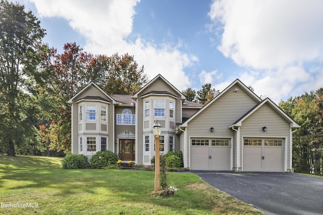 view of front of property with a garage and a front lawn