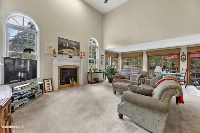 carpeted living room featuring a towering ceiling