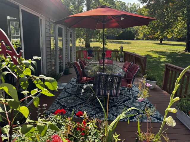 wooden deck featuring a lawn