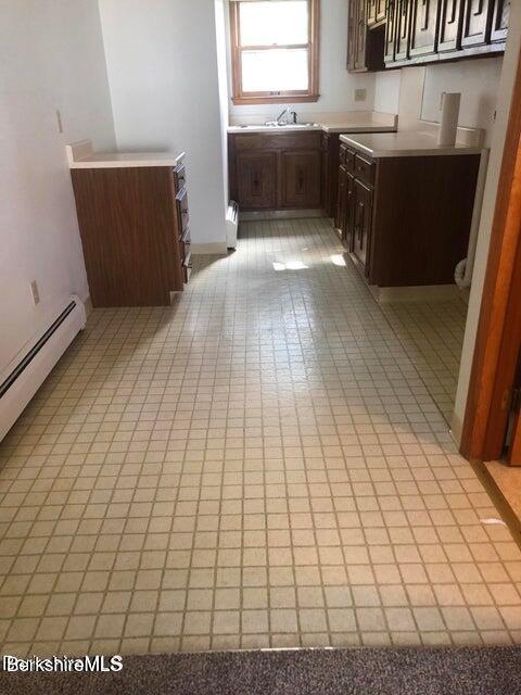 420-436 N Houghton St, Clarksburg, MA 01247 - kitchen with light countertops, light tile patterned floors, dark brown cabinetry, and a baseboard heating unit