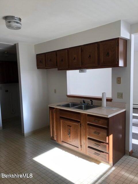 420-436 N Houghton St, Clarksburg, MA 01247 - kitchen featuring light countertops, dark brown cabinets, and a baseboard heating unit