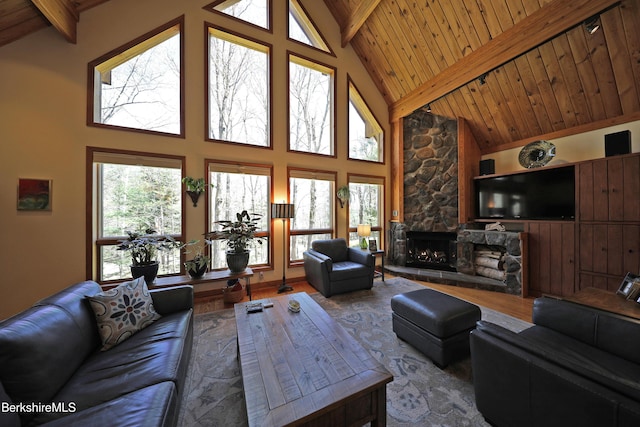 55 Mallard Dr, Becket, MA 01223 - living area with a wood ceiling with exposed beams, a fireplace, wood finished floors, healthy amount of natural light, and high vaulted ceiling