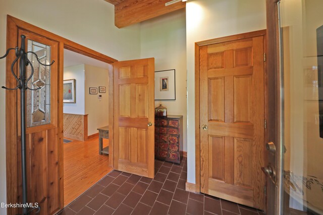 55 Mallard Dr, Becket, MA 01223 - foyer with beamed ceiling and dark tile patterned floors