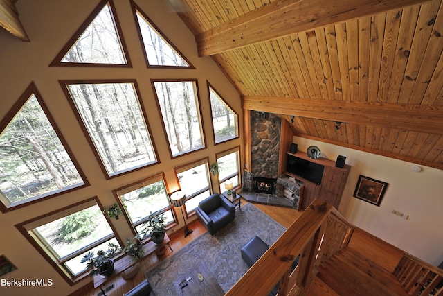 55 Mallard Dr, Becket, MA 01223 - living area featuring high vaulted ceiling, a wooden ceiling with exposed beams, wood finished floors, and a fireplace