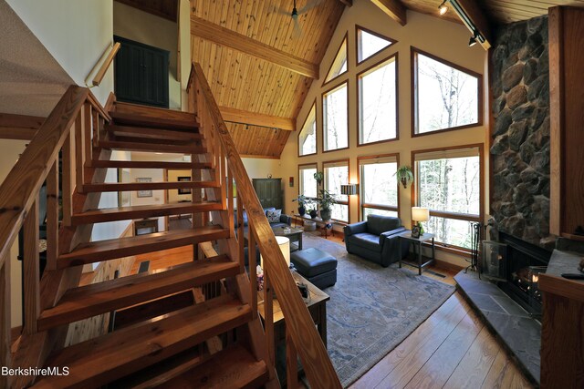 55 Mallard Dr, Becket, MA 01223 - staircase with a wood ceiling with exposed beams, high vaulted ceiling, hardwood / wood-style floors, and a wood stove