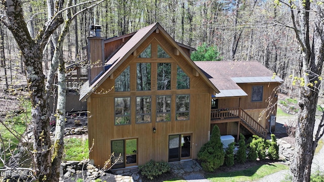 55 Mallard Dr, Becket, MA 01223 - rear view of property with a chimney, roof with shingles, a forest view, stairway, and a deck