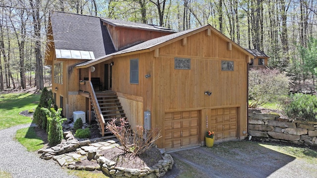 55 Mallard Dr, Becket, MA 01223 - view of property exterior featuring a shingled roof, driveway, stairs, and an attached garage
