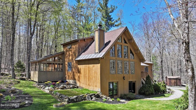55 Mallard Dr, Becket, MA 01223 - back of house featuring a chimney, a sunroom, a metal roof, a shed, and a standing seam roof