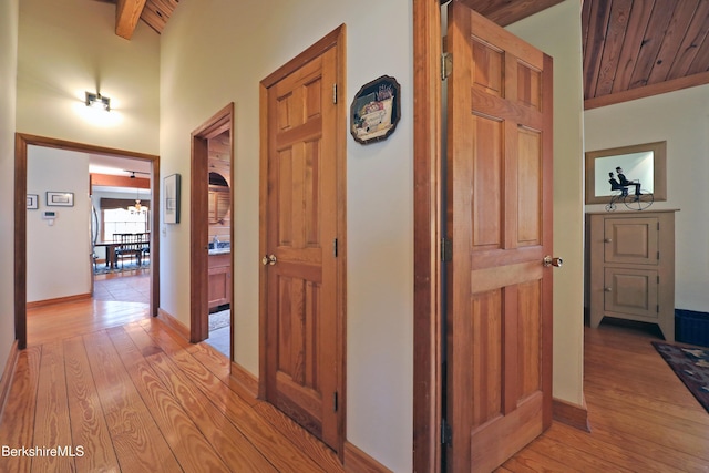 55 Mallard Dr, Becket, MA 01223 - hallway with light wood-style floors, a wood ceiling with exposed beams, and a chandelier