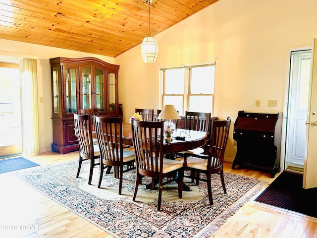 dining area featuring a wealth of natural light, light hardwood / wood-style flooring, wood ceiling, and lofted ceiling