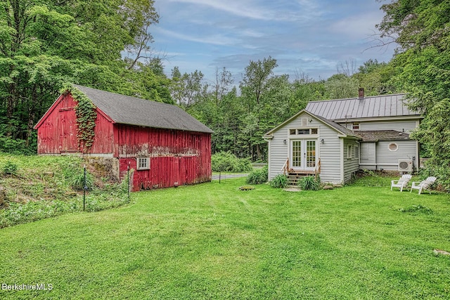 132 Sandisfield Rd, Sandisfield, MA 01255 - view of green lawn featuring french doors, an outbuilding, and a barn