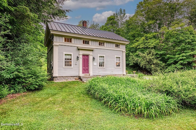 132 Sandisfield Rd, Sandisfield, MA 01255 - view of front of house with a chimney, a front lawn, a standing seam roof, and a metal roof