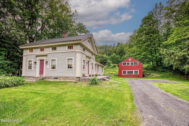 132 Sandisfield Rd, Sandisfield, MA 01255 - view of front of house featuring a chimney, a front yard, and a metal roof
