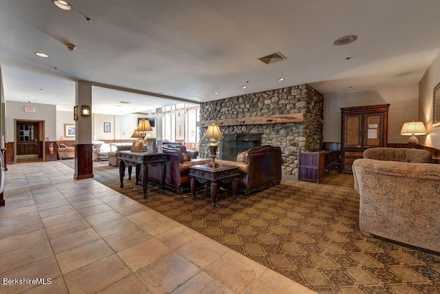 living room featuring a stone fireplace