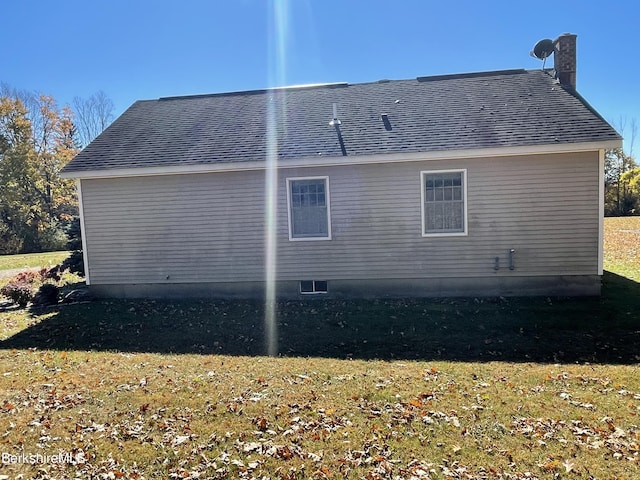 view of side of home featuring a yard