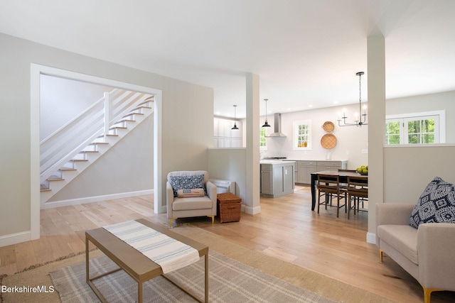60 Parsley Ln, Sheffield, MA 01257 - living room with light wood finished floors, a chandelier, stairs, and baseboards