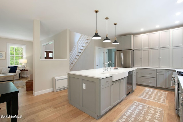 60 Parsley Ln, Sheffield, MA 01257 - kitchen featuring gray cabinets, appliances with stainless steel finishes, a sink, light wood-style floors, and light countertops