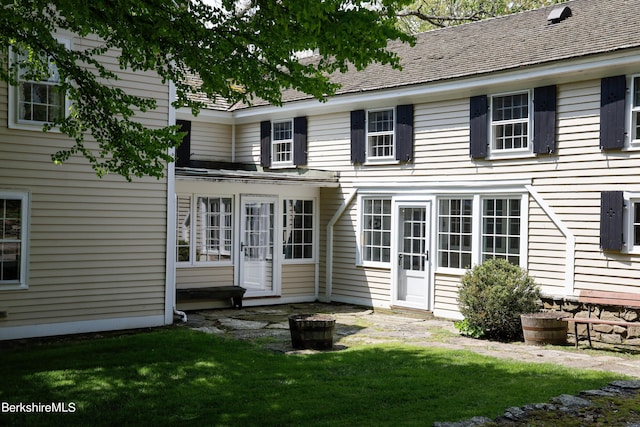 rear view of property with a yard