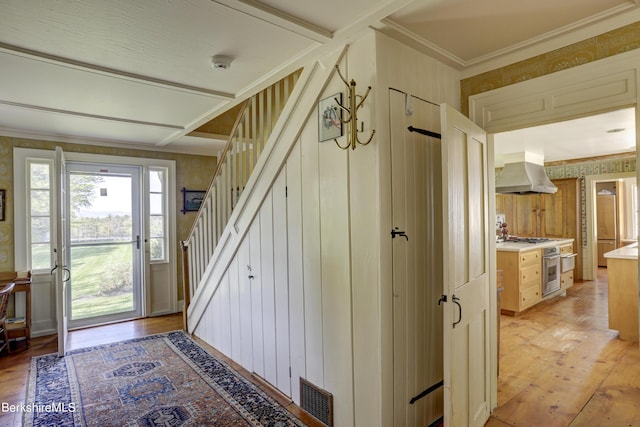 interior space featuring ornamental molding and light hardwood / wood-style flooring