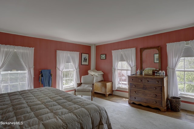 bedroom with multiple windows and ornamental molding